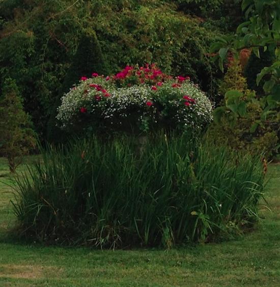 A large weathered stone garden urn, W.3ft 5in. H.3ft 11in.